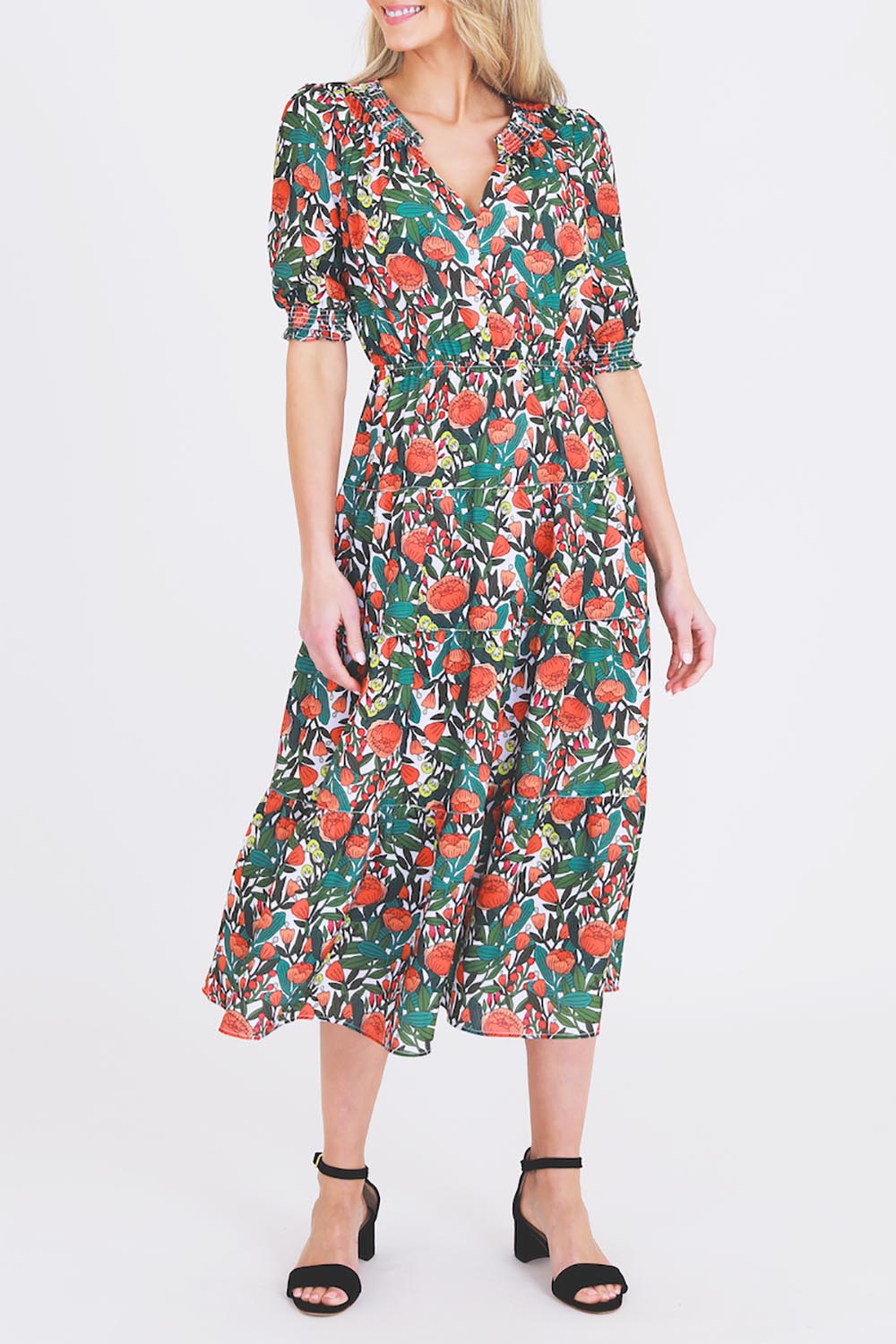 A model wearing the Maisie Floral Dress in colour Rosetta (Green), from the front, cropped image