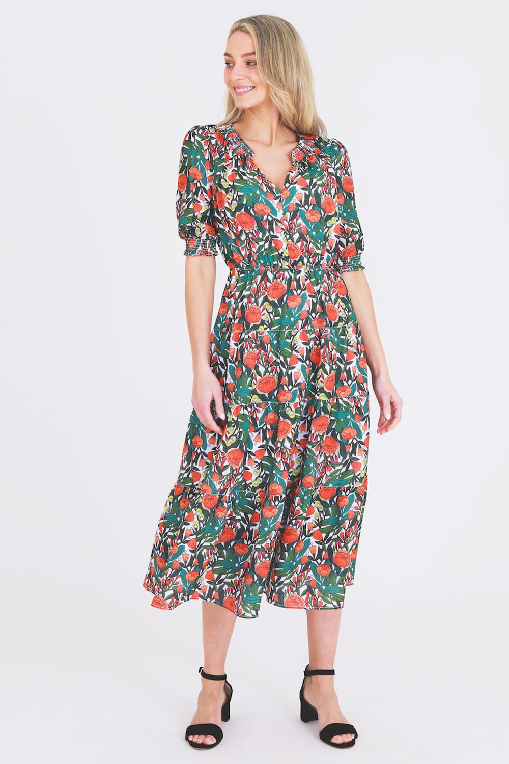 A model wearing the Maisie Floral Dress in colour Rosetta (Green), from the front, showing the whole outfit