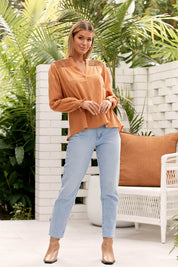 A model wearing the Jessica Cotton Blouse in colour Rust, from the front, showing the whole outfit