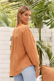 A model wearing the Jessica Cotton Blouse in colour Rust, from the front, showing the whole outfit