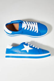 A model wearing size 37 of the Pixie Leather Sneaker in colour Cobaltwhit (Blue), from the front, showing the whole outfit