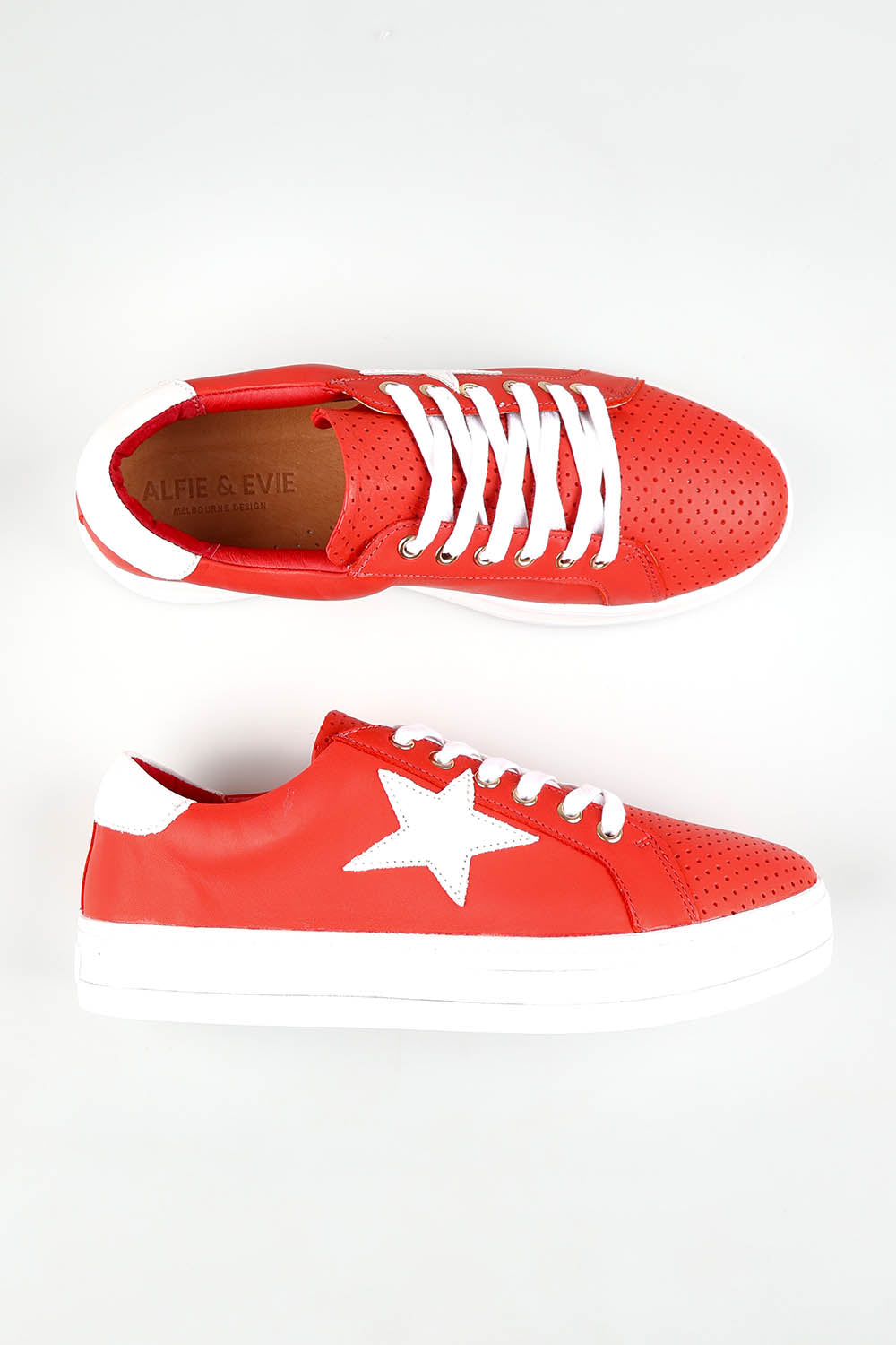 A model wearing size 37 of the Pixie Leather Sneaker in colour Firewhite (Red), from the front, showing the whole outfit