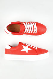 A model wearing size 37 of the Pixie Leather Sneaker in colour Firewhite (Red), from the front, showing the whole outfit