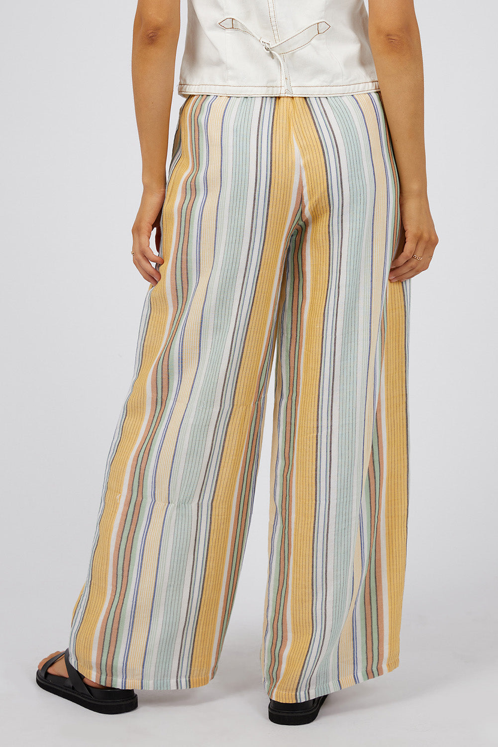 A model wearing the Cindy Pant in colour Green, from the back