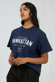 A model wearing the Manhattan Oversized Cotton Tee in colour Navy (Blue), from the front, cropped image