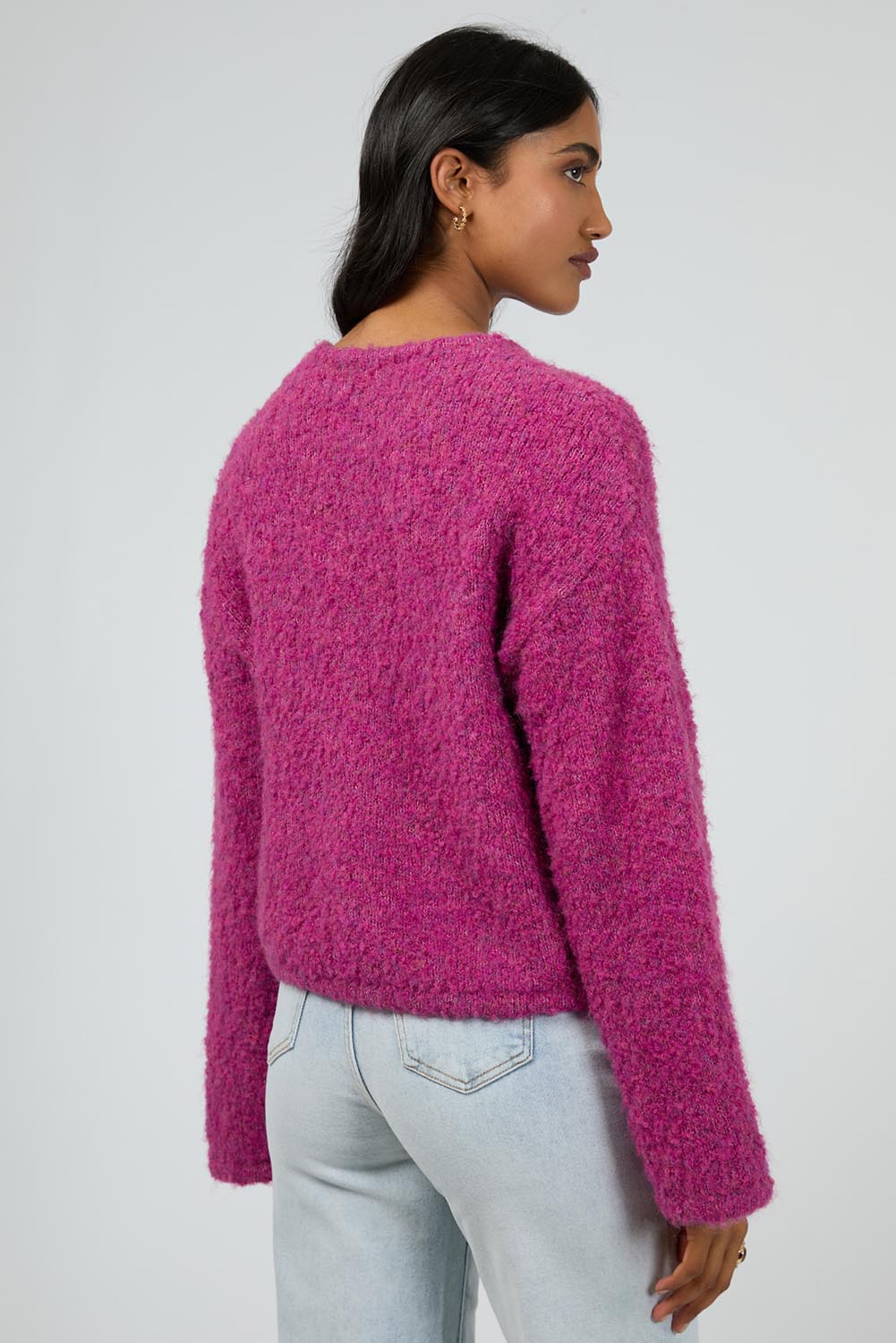 A model wearing the Cleo Knit in colour Mauve (Pink), from the back