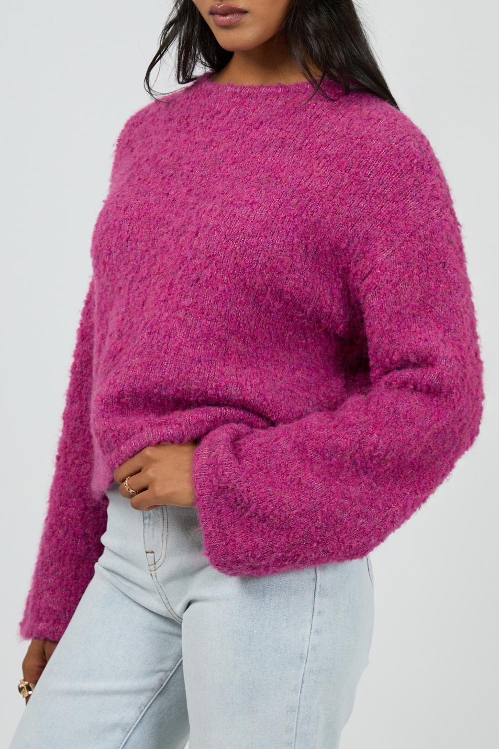 A model wearing the Cleo Knit in colour Mauve (Pink), from the front, cropped image