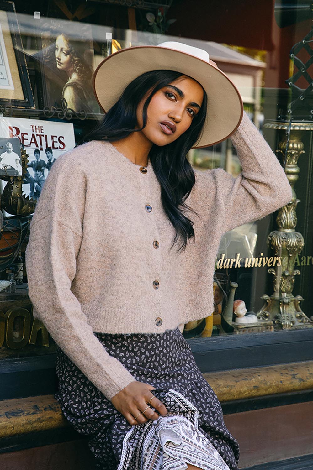 A model wearing the Billie Jean Cardi in colour Oat, from the front, showing the whole outfit