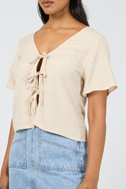 A model wearing the Hampton Top in colour Oat, from the front, cropped image