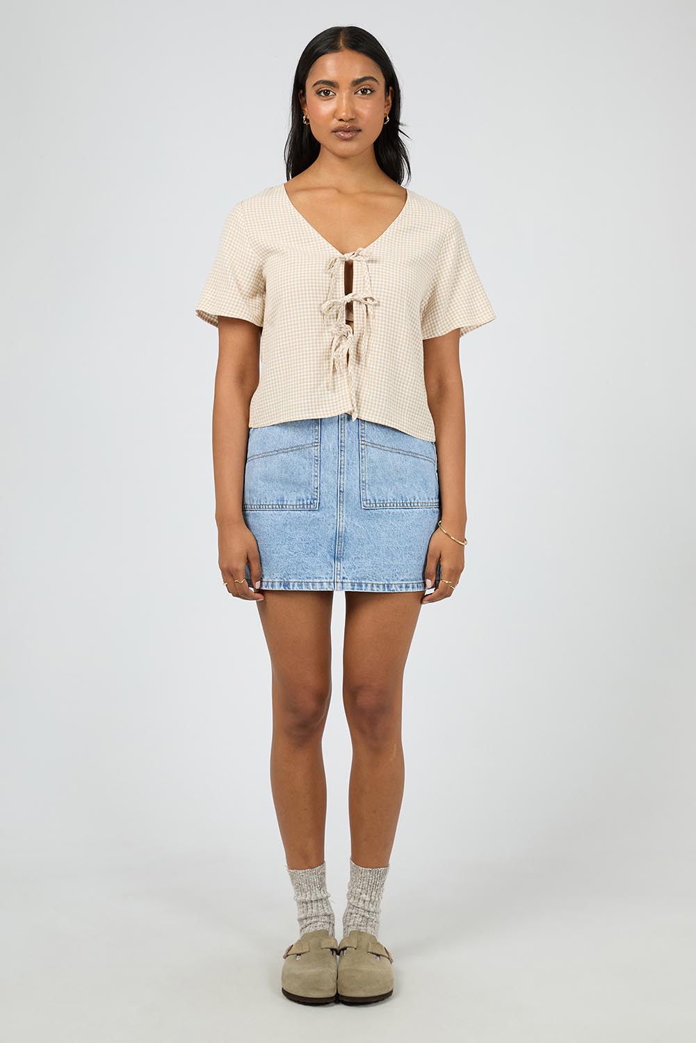 A model wearing the Hampton Top in colour Oat, from the front, showing the whole outfit