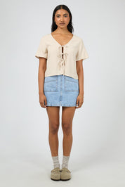 A model wearing the Hampton Top in colour Oat, from the front, showing the whole outfit