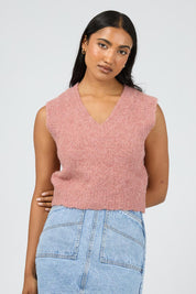 A model wearing the Leah Knit Vest in colour Quartz (Pink), from the front, cropped image