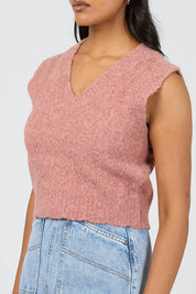 A model wearing the Leah Knit Vest in colour Quartz (Pink), from the front, cropped image