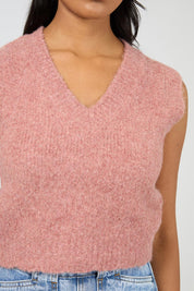A model wearing the Leah Knit Vest in colour Quartz (Pink), from the front, cropped image