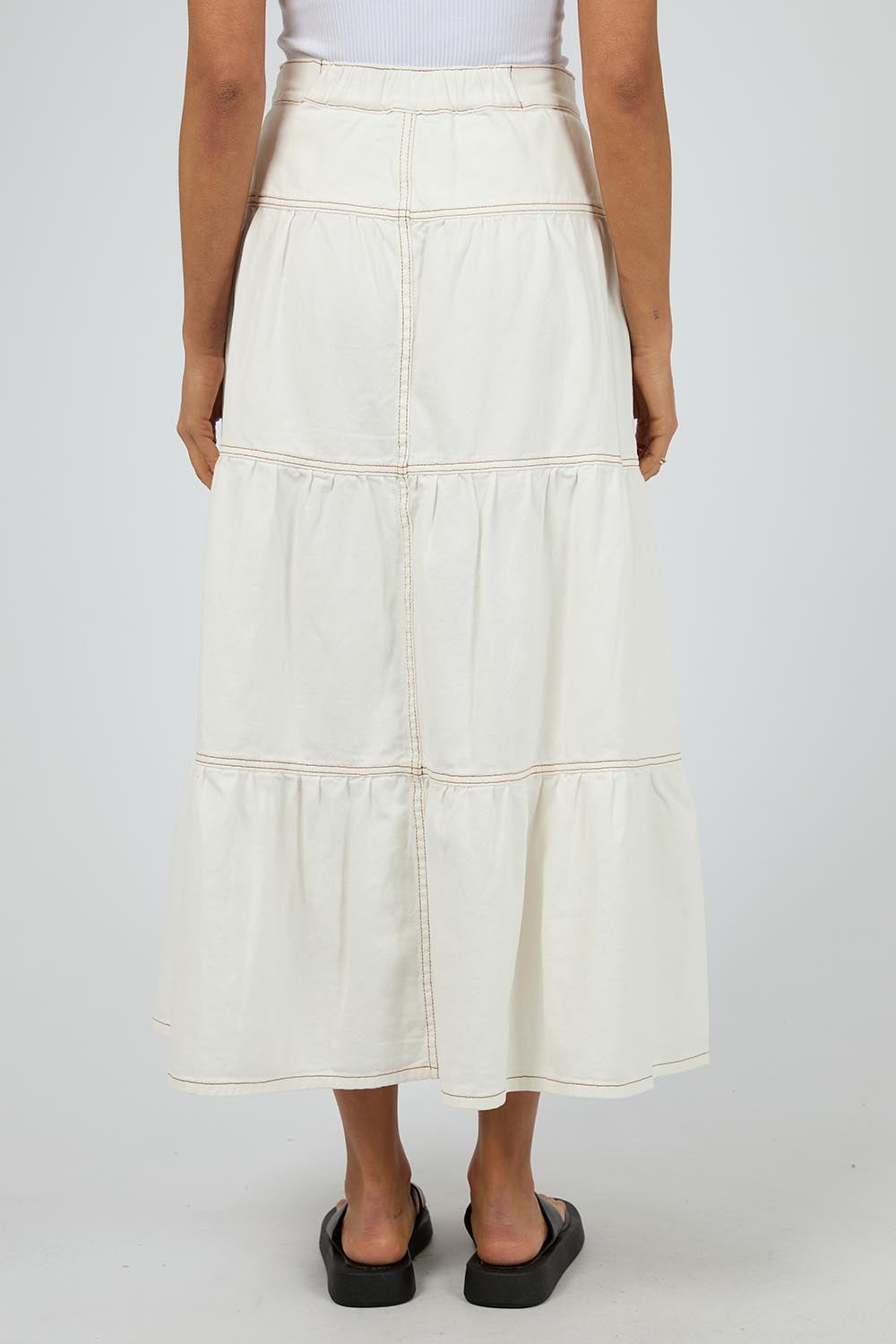 A model wearing the Coco Denim Maxi Skirt in colour Vinwhite (White), from the back