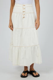 A model wearing the Coco Denim Maxi Skirt in colour Vinwhite (White), from the front, cropped image