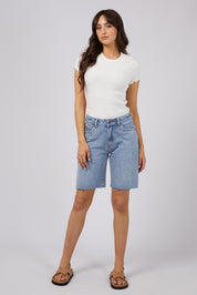 A model wearing the Lexie Denim Short in colour Lblue (Blue), from the front, showing the whole outfit