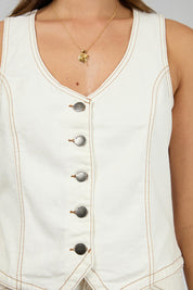 A model wearing the Korin Denim Vest in colour Vwhite (White), from the front, cropped image