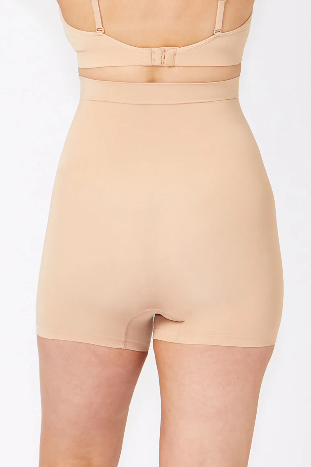 A model wearing the Powerlite High Waisted Short in colour Beige, from the back