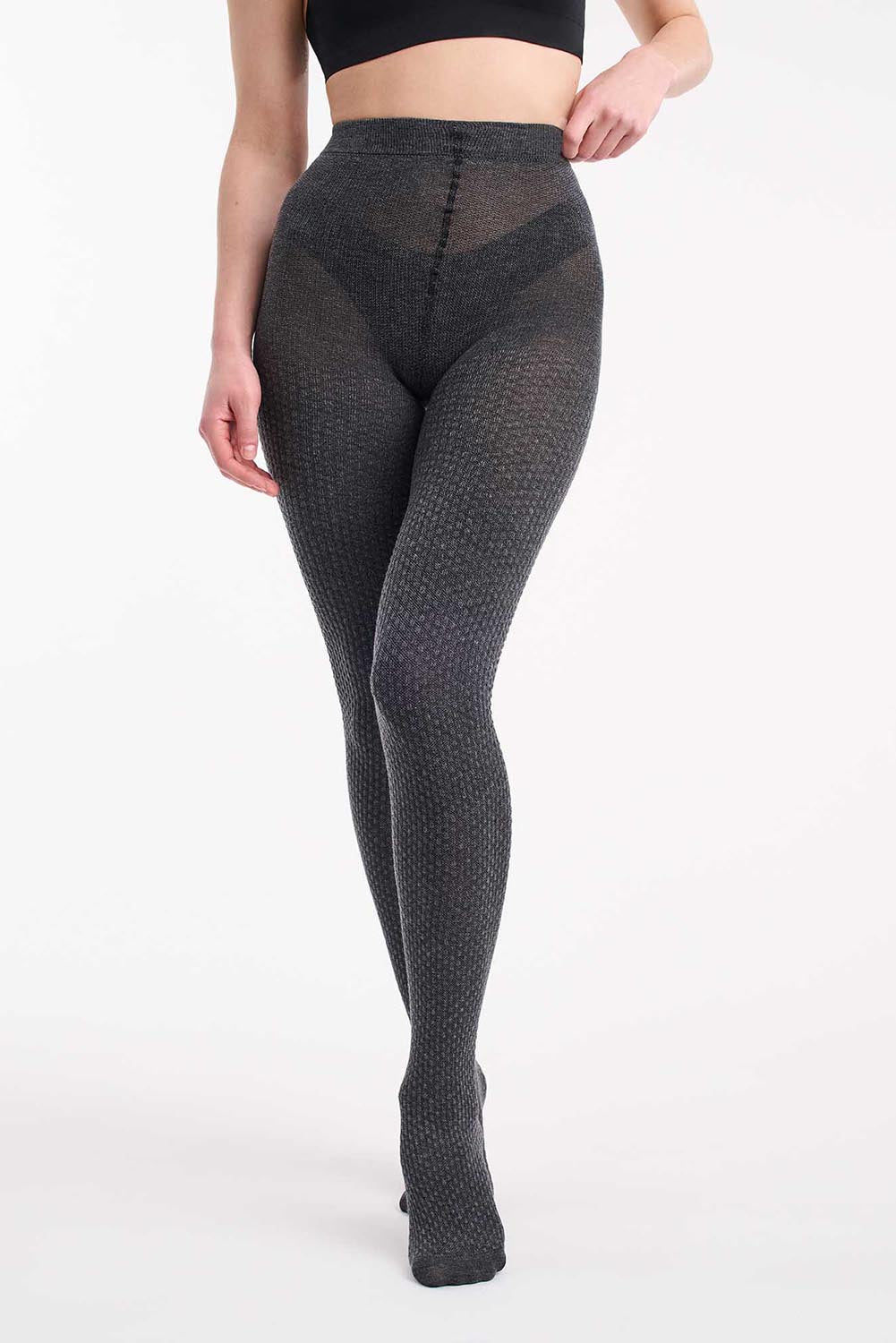 A model wearing the Textured Knit Tights in colour Charcoal (Grey), from the front, cropped image