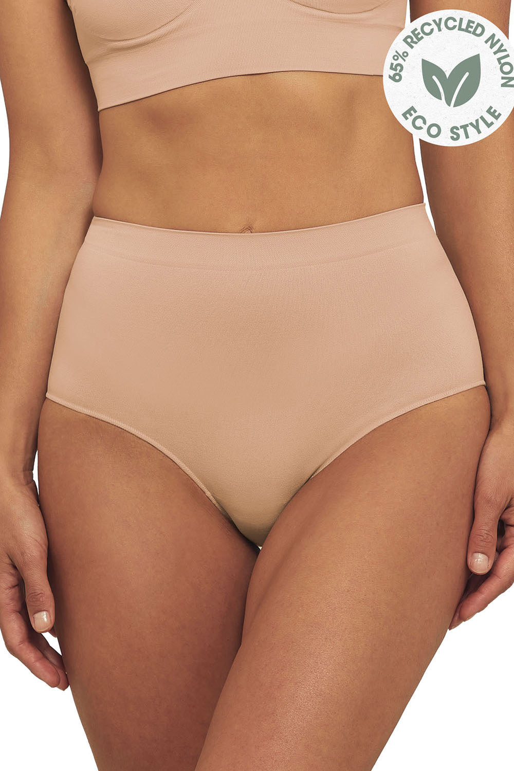 A model wearing the Bare Essentials Full Brief in colour Rosebeige, from the front, cropped image