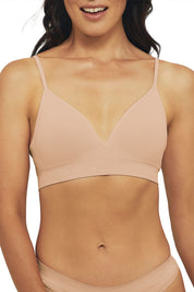 A model wearing the Bare Essentials Moulded Wirefree Bra in colour Rosebeige, from the front, cropped image