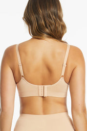 A model wearing the Bare Essentials Support Wirefree Bra in colour Beige, from the back