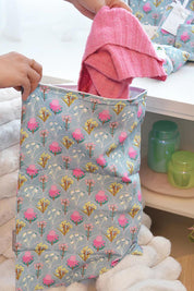 A model wearing the Australian Made Travel Laundry Bag in colour Wildflower (Blue), from the front, showing the whole outfit