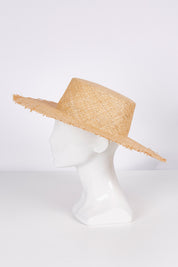 A model wearing size OneSize of the Leonora Bao Straw Sun Hat in colour Natural, from the front, showing the whole outfit