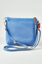A model wearing size OneSize of the Alexis Leather Crossbody in colour Cornflower (Blue), from the front, showing the whole outfit