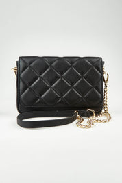 A model wearing the Sarah Leather Quilted Crossbody in colour Black (Black), from the front, showing the whole outfit