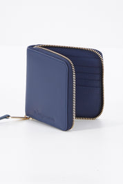 A model wearing size OneSize of the Zoe Leather Wallet in colour Navy (Blue), from the front, showing the whole outfit