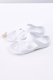 A model wearing size 37 of the Indy Orthotic Support Slides in colour White (White), from the front, showing the whole outfit