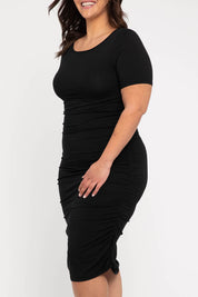 A model wearing the Jasper Ruched Dress in colour Black (Black), from the front, cropped image