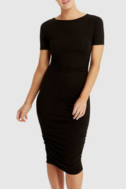 A model wearing the Jasper Ruched Dress in colour Black (Black), from the front, cropped image