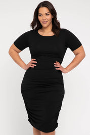 A model wearing the Jasper Ruched Dress in colour Black (Black), from the front, cropped image