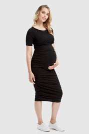 A model wearing the Jasper Ruched Dress in colour Black (Black), from the front, showing the whole outfit