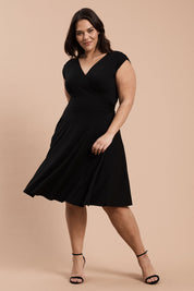 A model wearing the Wrap Dress in colour Black (Black), from the front, showing the whole outfit