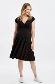 A model wearing the Wrap Dress in colour Black (Black), from the front, showing the whole outfit