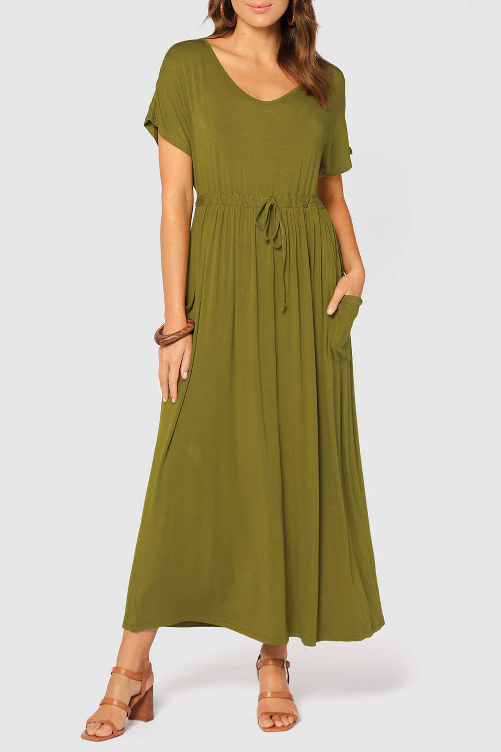A model wearing the Mila Maxi Dress in colour Cardamom (Green), from the front, cropped image