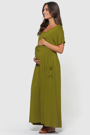 A model wearing the Mila Maxi Dress in colour Cardamom (Green), from the front, showing the whole outfit