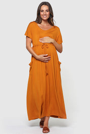 A model wearing the Mila Maxi Dress in colour Tumeric, from the front, showing the whole outfit
