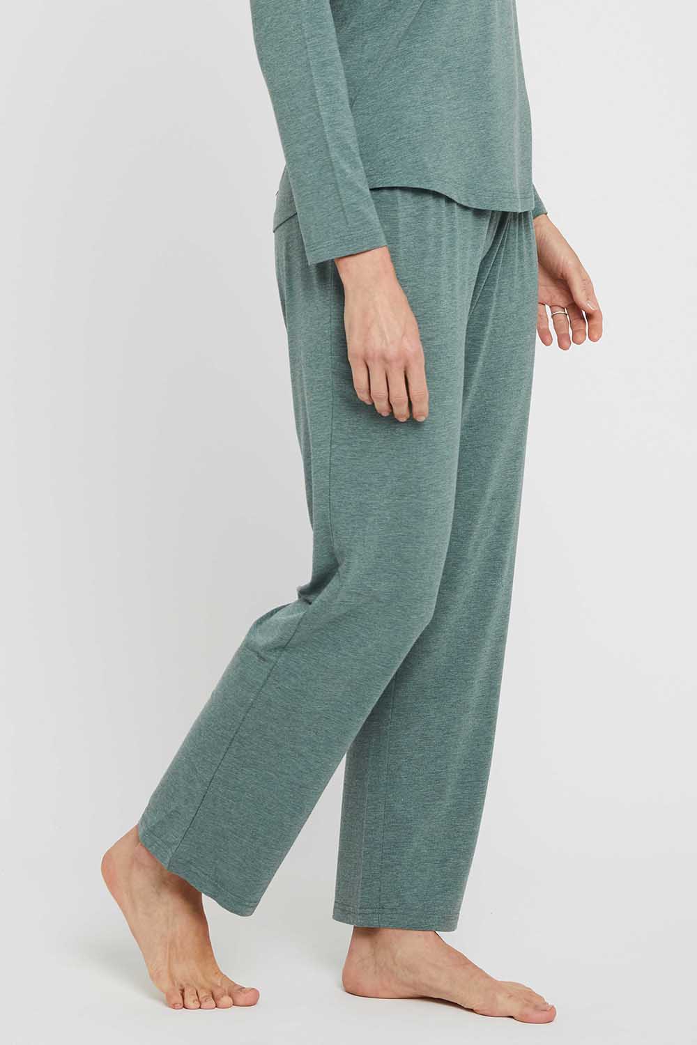 A model wearing the Relax PJ Long Bamboo Pants in colour Moss (Green), from the front, cropped image