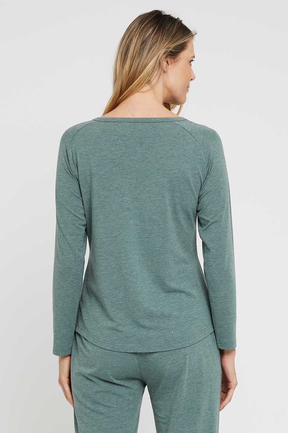 A model wearing the Henley Long Sleeve Bamboo Top in colour Moss (Green), from the back