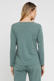 A model wearing the Henley Long Sleeve Bamboo Top in colour Moss (Green), from the back