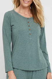 A model wearing the Henley Long Sleeve Bamboo Top in colour Moss (Green), from the front, cropped image