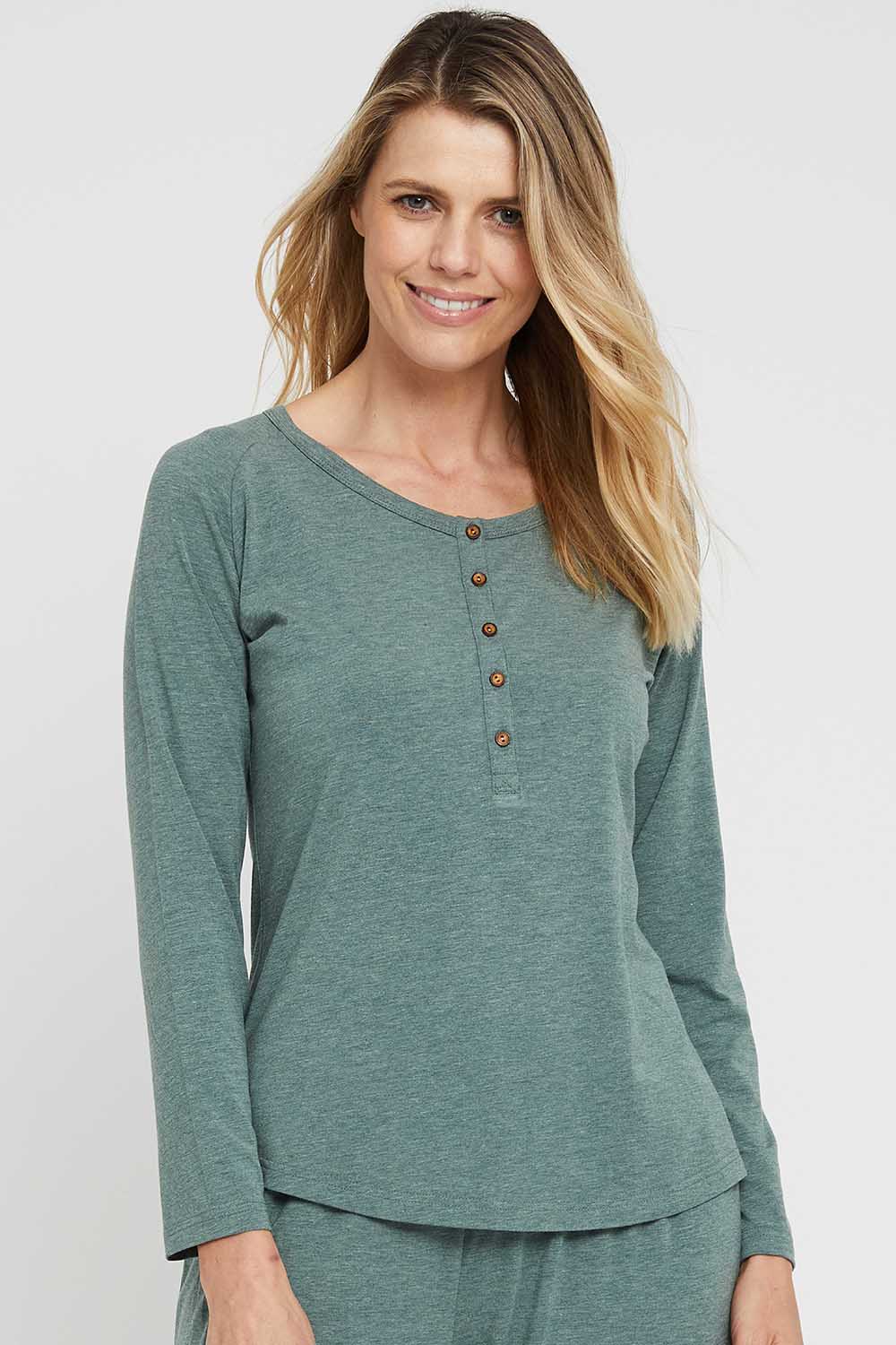 A model wearing the Henley Long Sleeve Bamboo Top in colour Moss (Green), from the front, cropped image