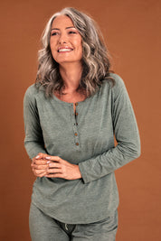 Model Luisa wearing size S of the Henley Long Sleeve Bamboo Top in colour Moss (Green), from the front, cropped image