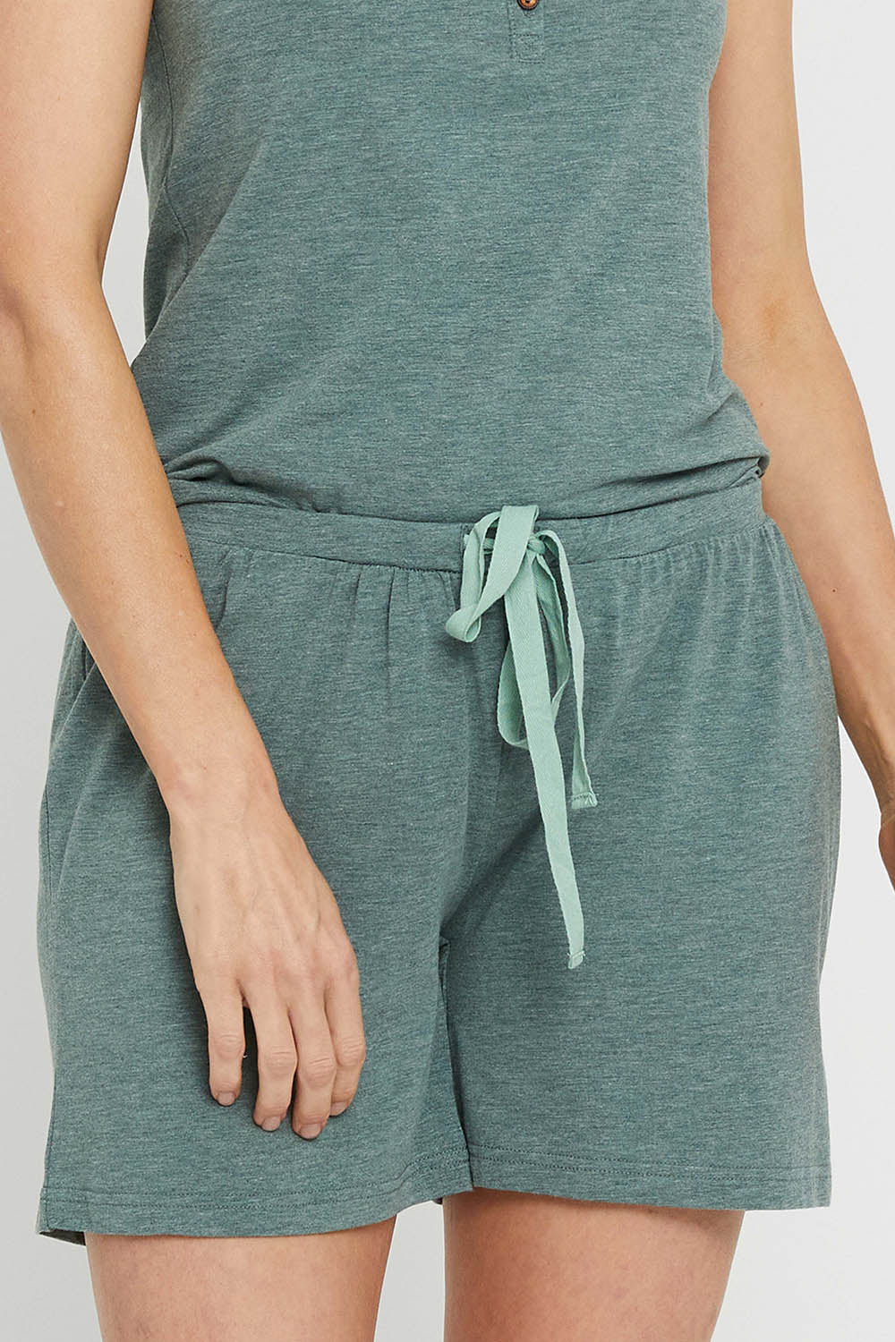 A model wearing the Bamboo Shorts in colour Moss (Green), from the front, cropped image