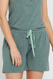 A model wearing the Bamboo Shorts in colour Moss (Green), from the front, cropped image